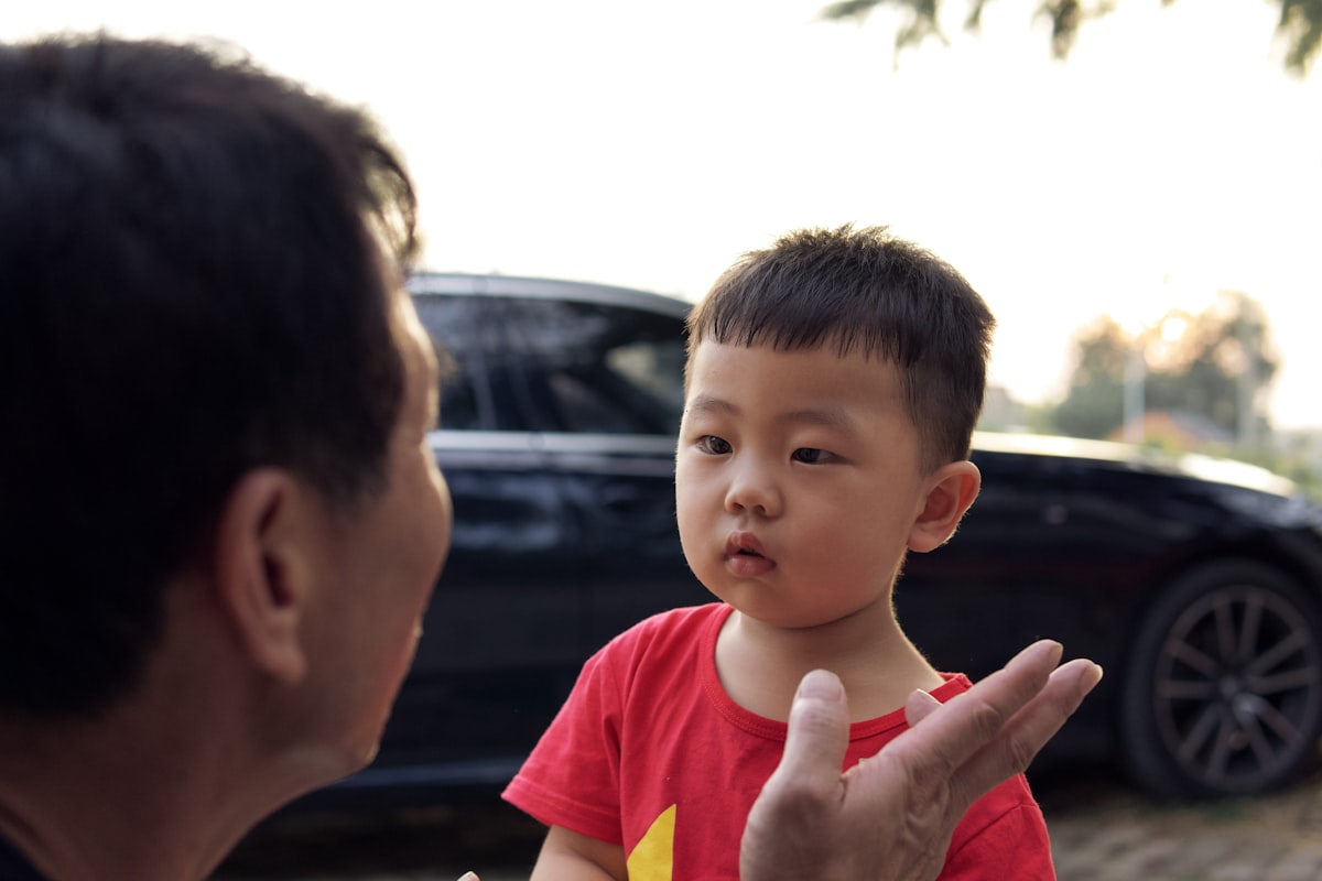 A father explaining something to his young son, who listens with rapt curiosity